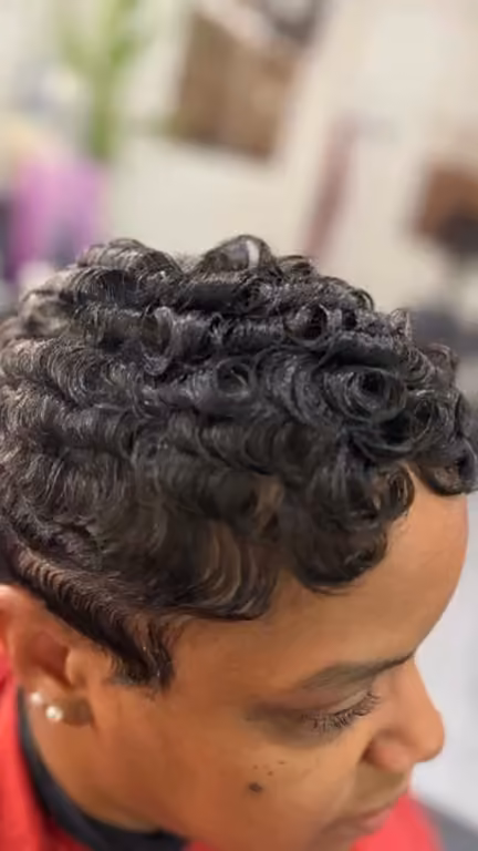 Short sculpted black curls, seen from above