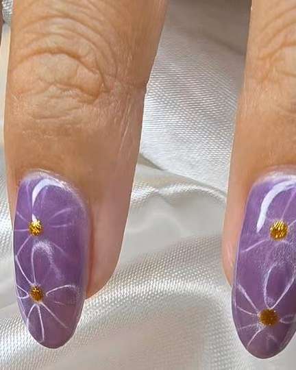 Lavender nails with white floral line art and gold dots