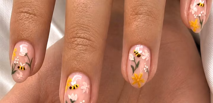 Soft pink nails with hand-painted flowers and little bees