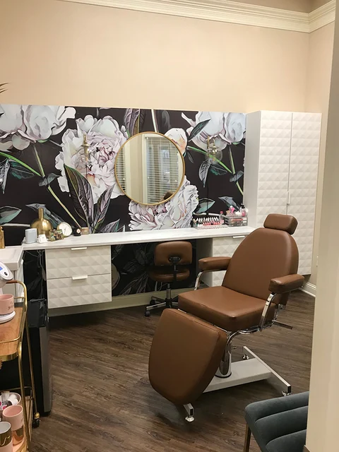 Brown styling chairs and wide mirrors in an individual salon suite.