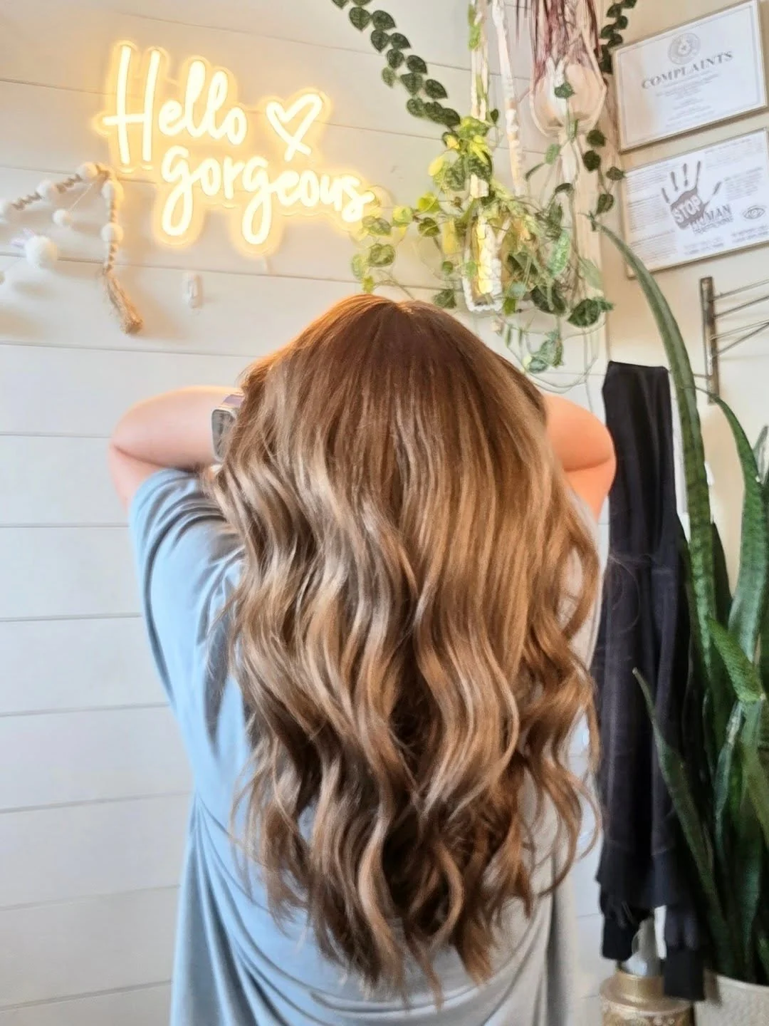 Blonde waves against the studio’s greenery