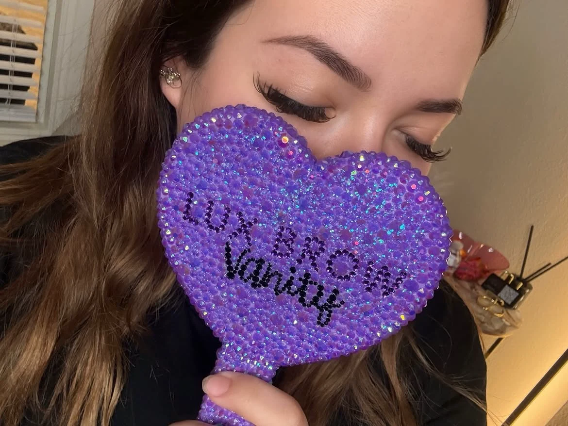 Close-up of finished brows above a purple Lux Brow Vanity mirror.