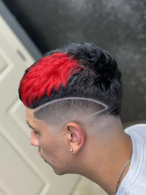 Red and black hair with a curved shaved line, from D’Fade 99’s portfolio