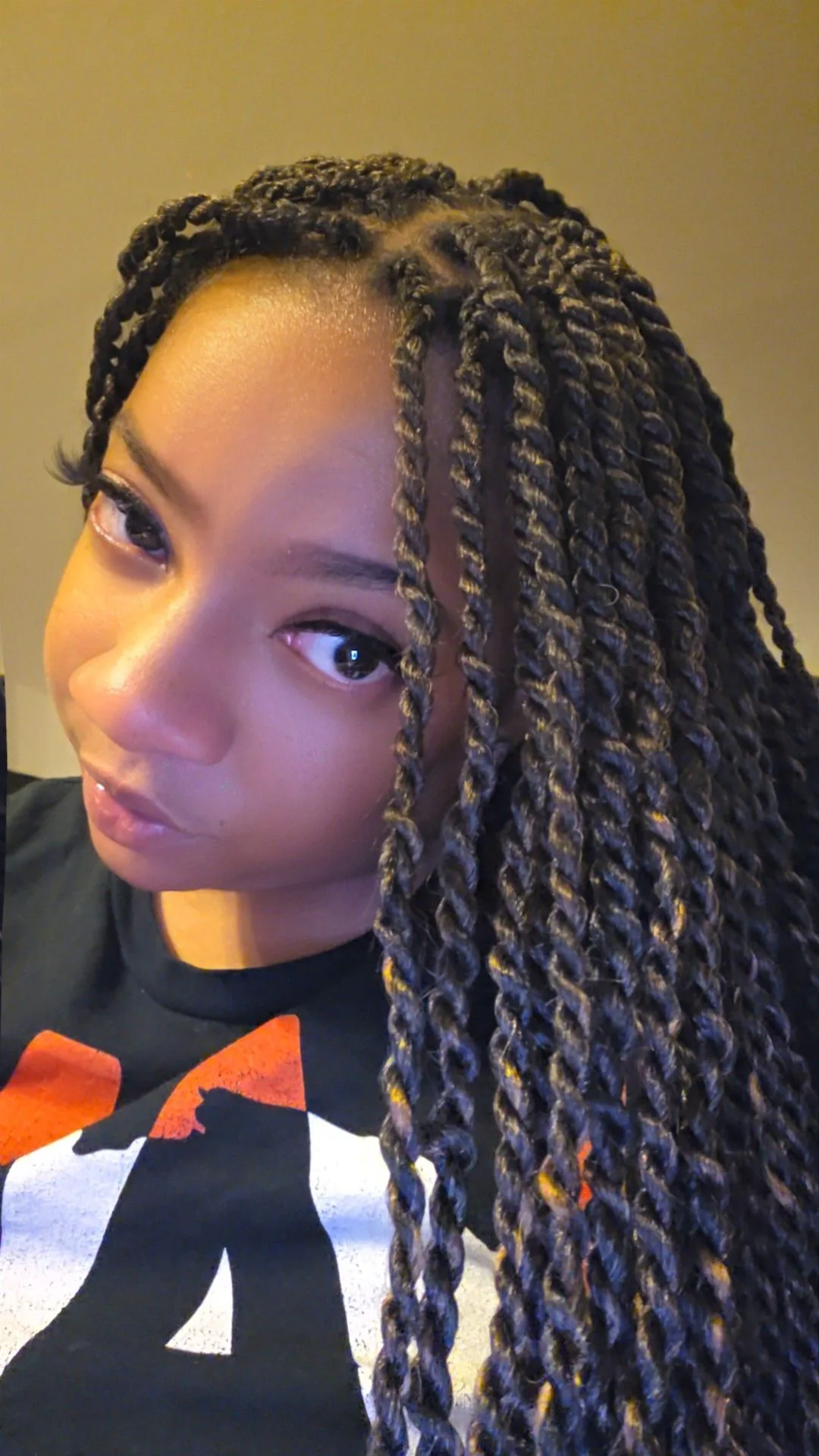 A client wearing long twists, from a Booksy review photo